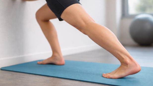 achilles tendon recovery time shown with barefoot calf stretch highlighting Achilles tendon