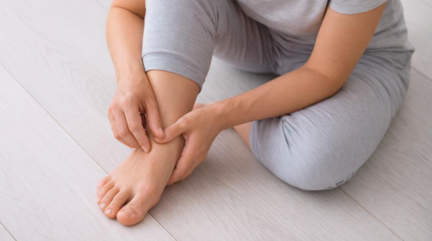 Early sign of bunion with person examining big toe