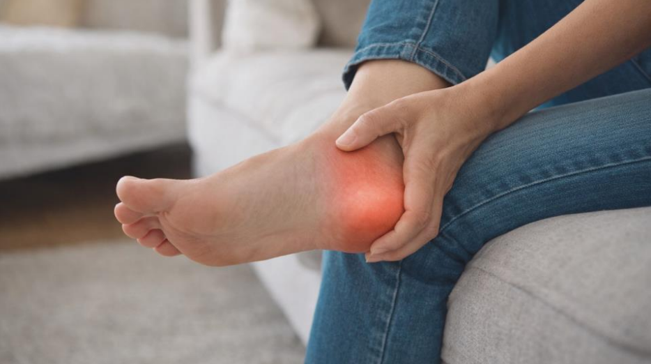 Person holding heel and ankle showing plantar fasciitis ankle pain